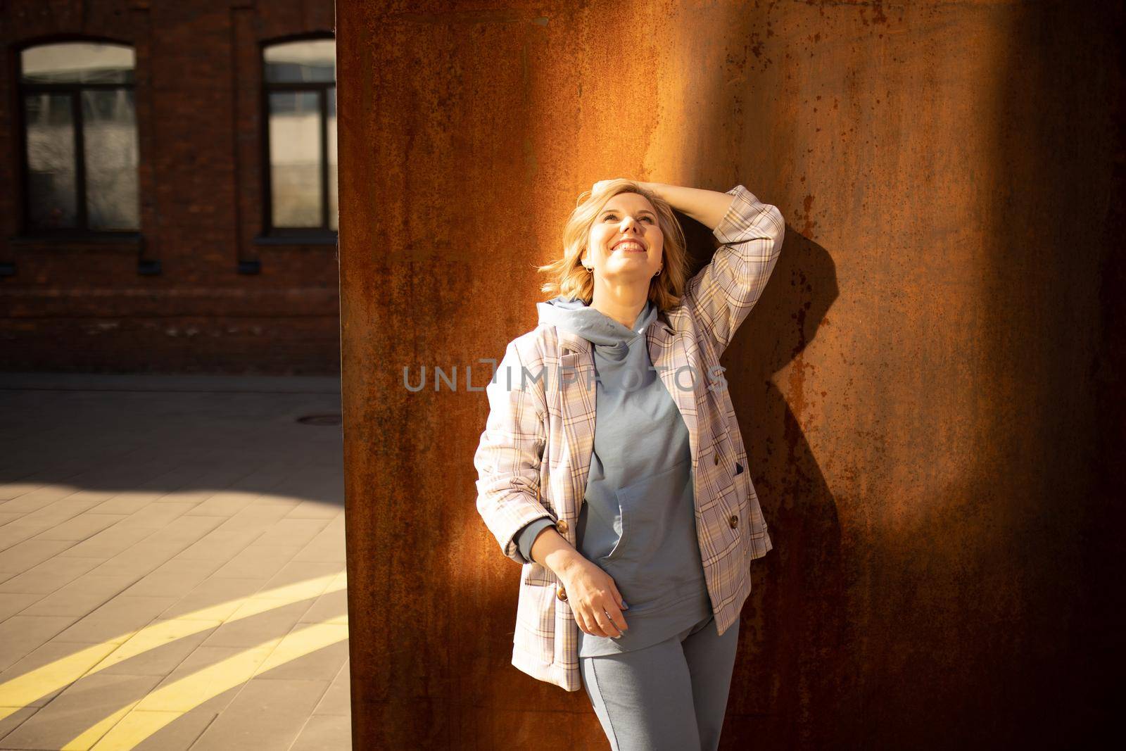 Girl against a rusty wall outdoor. High quality photo