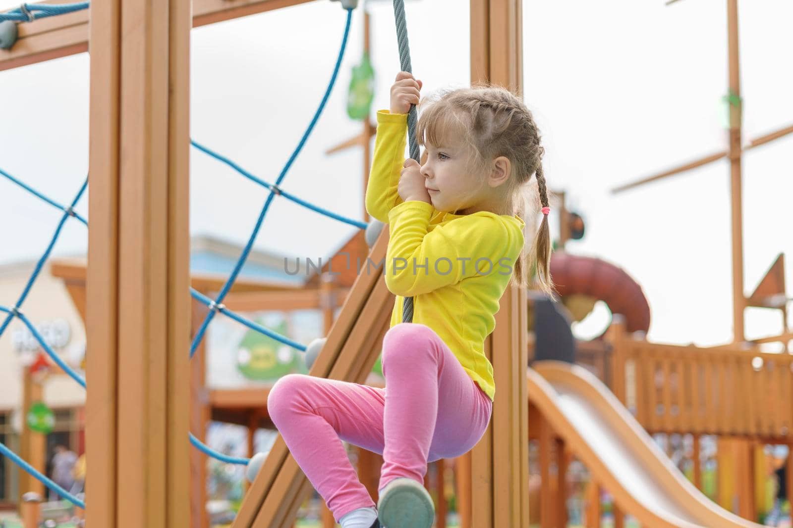 cute baby playing and climbing on the playground by Lena_Ogurtsova