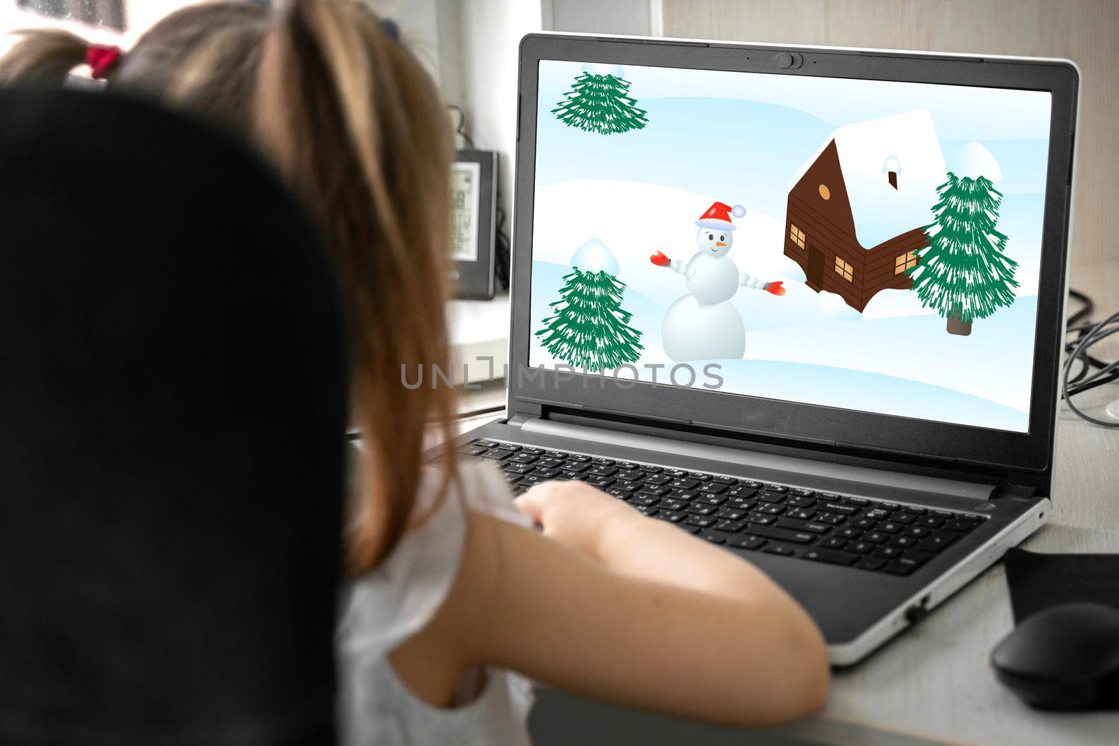 a child watches a cartoon about winter on a laptop by Lena_Ogurtsova