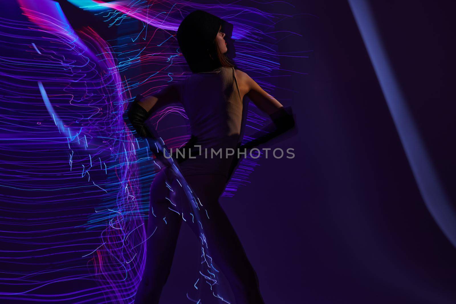 Positive young woman neon lines light posing studio model unaltered. High quality photo