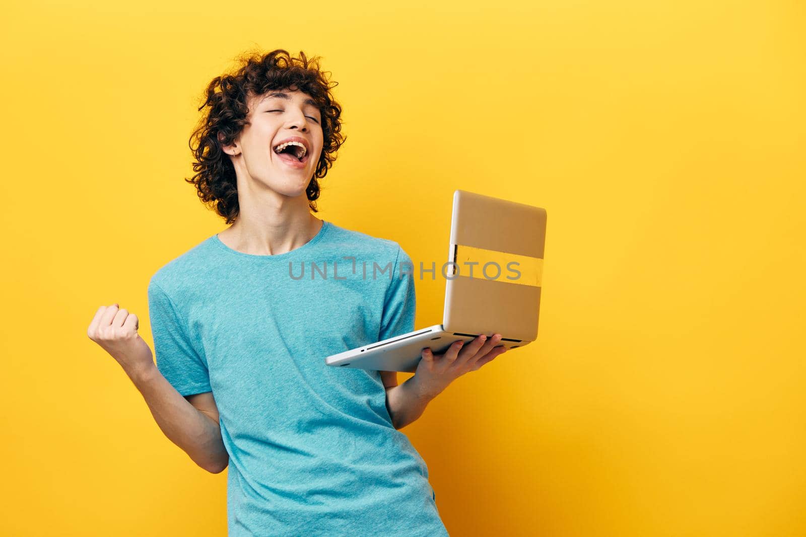 student in blue t-shirts with laptop internet cropped view. High quality photo