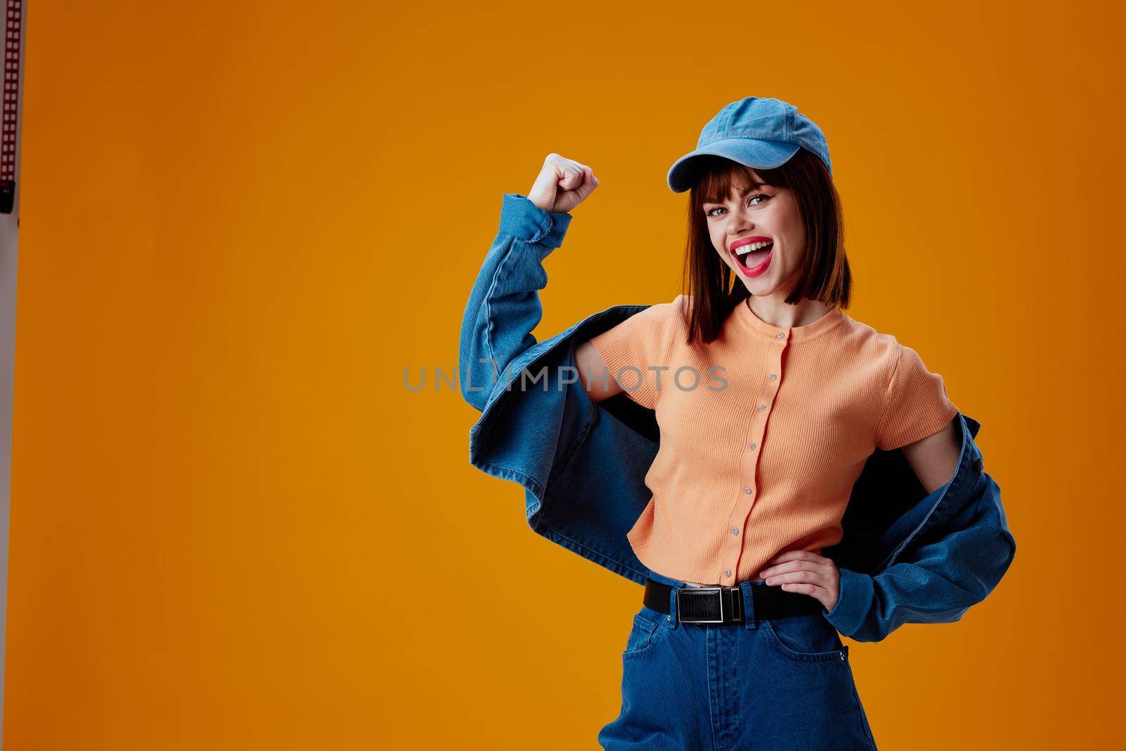 pretty woman stylish denim clothing posing yellow background unaltered by SHOTPRIME