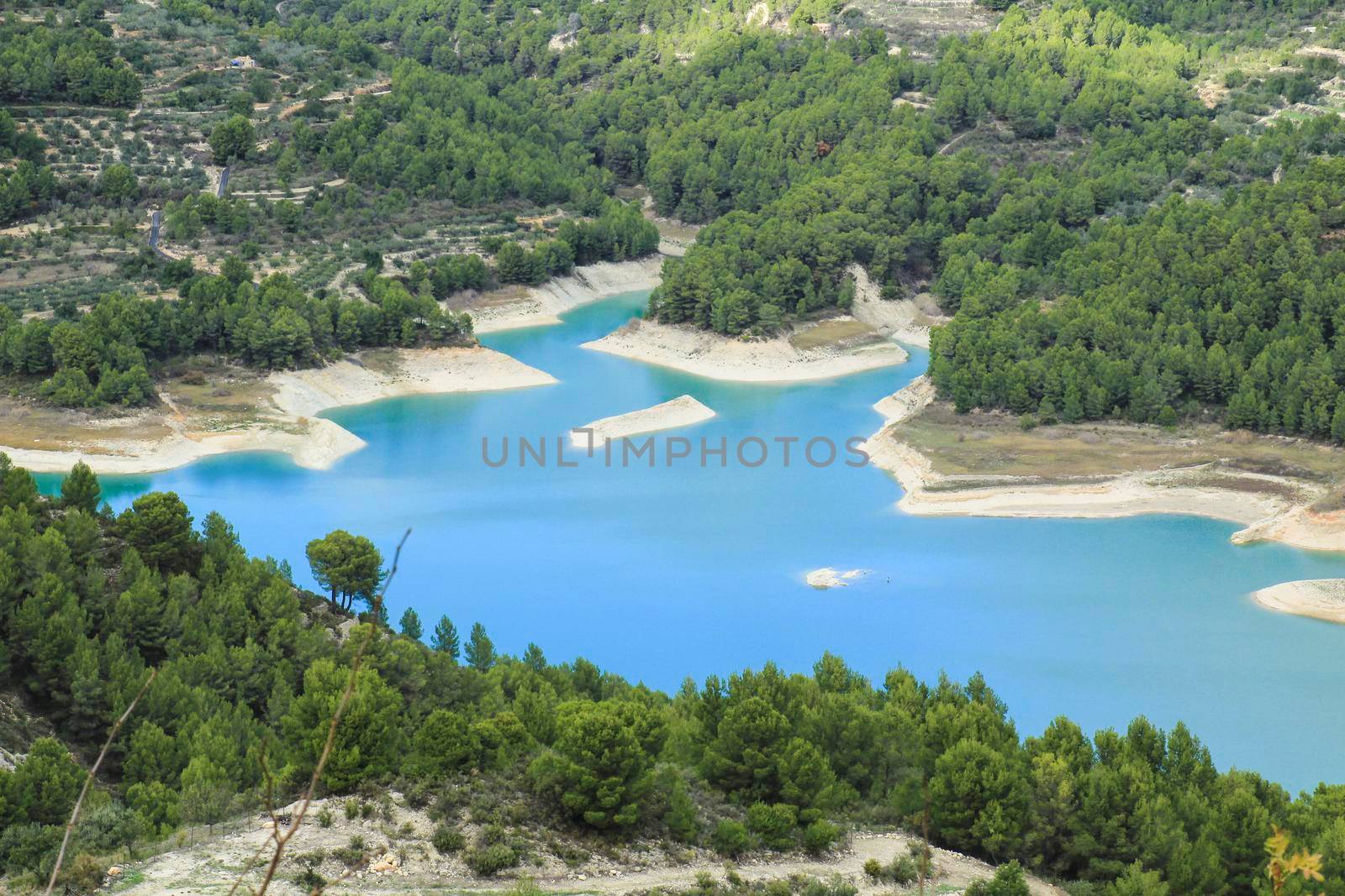 The swamp of Guadalest village surrounded by vegetation and mountains on a sunny day