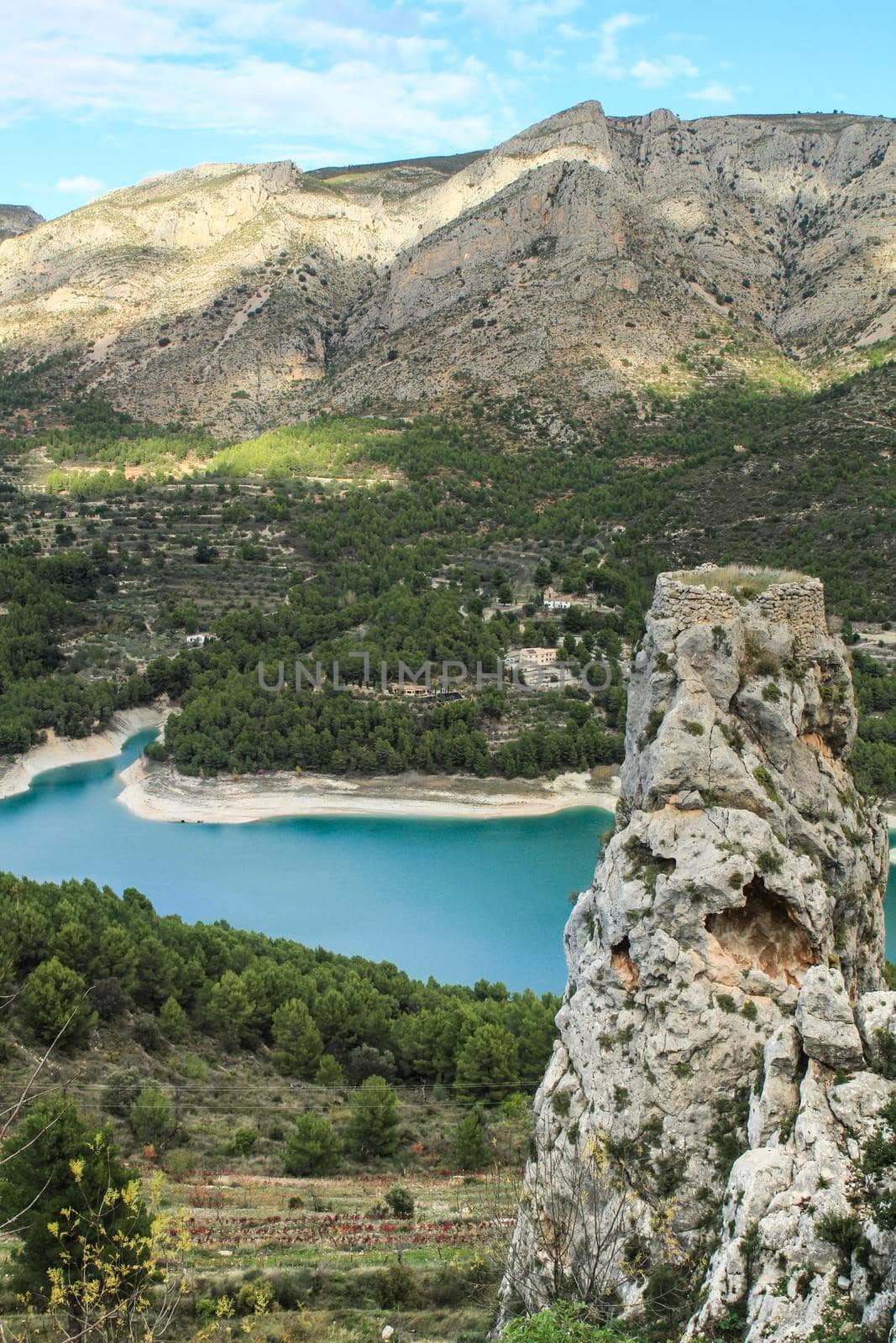 Beautiful view of Guadalest village surrounded by vegetation, mountains and the walls of the Castle