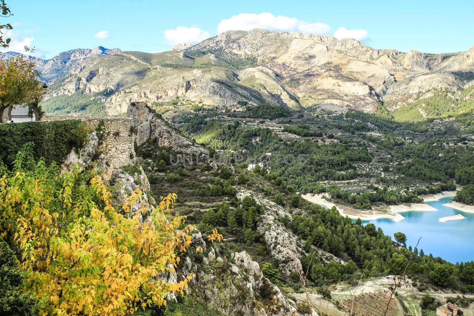Beautiful view of Guadalest village surrounded by vegetation, mountains and the walls of the Castle