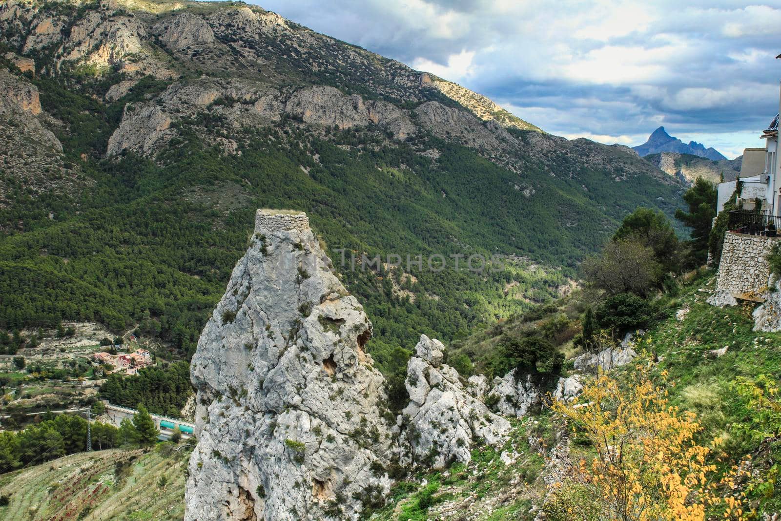 Beautiful view of Guadalest village surrounded by vegetation, mountains and the walls of the Castle