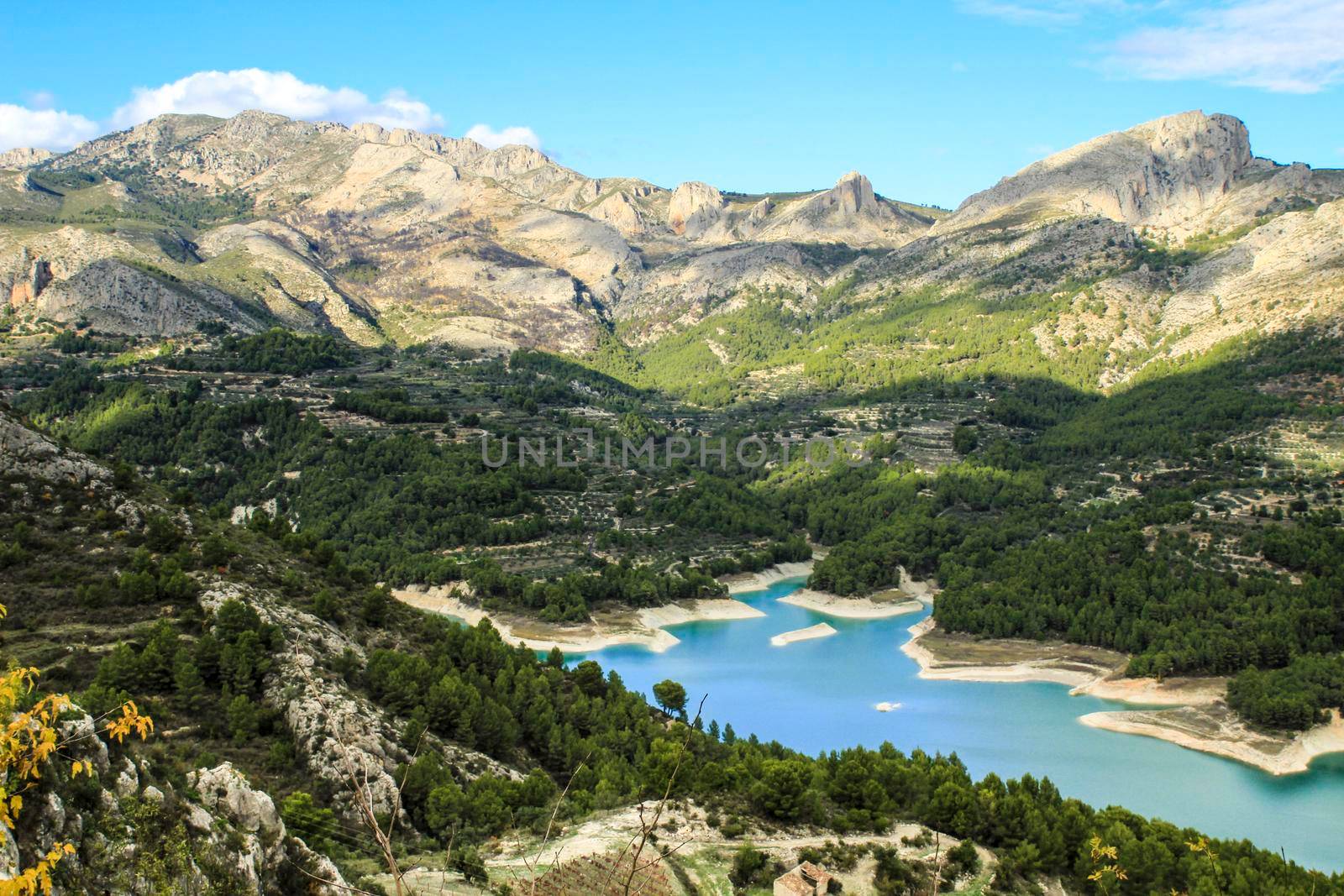 The swamp of Guadalest village surrounded by vegetation and mountains on a sunny day