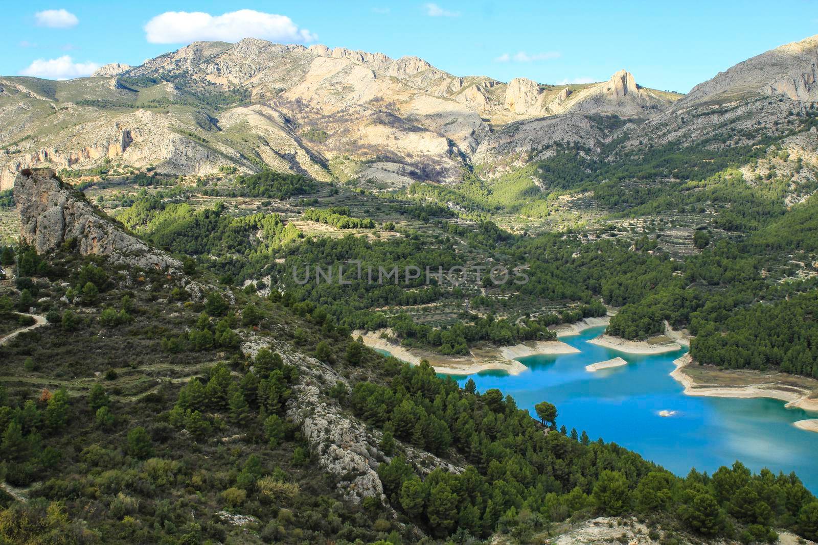 The swamp of Guadalest village surrounded by vegetation and mountains on a sunny day