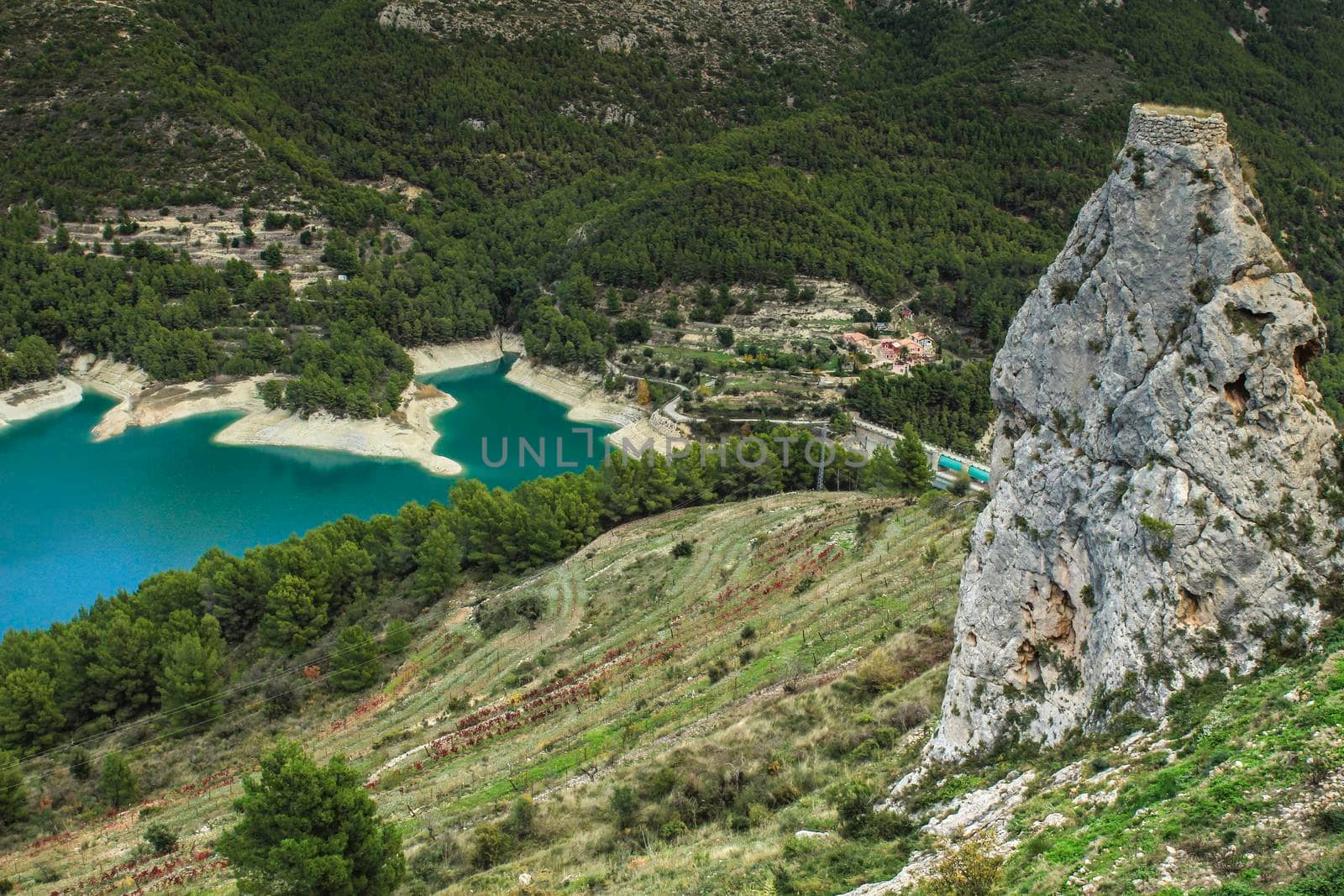 Beautiful view of Guadalest village surrounded by vegetation, mountains and the walls of the Castle