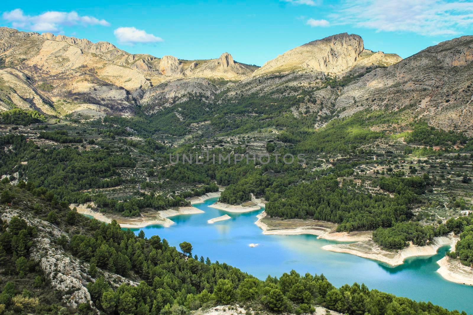 The swamp of Guadalest village surrounded by vegetation and mountains on a sunny day
