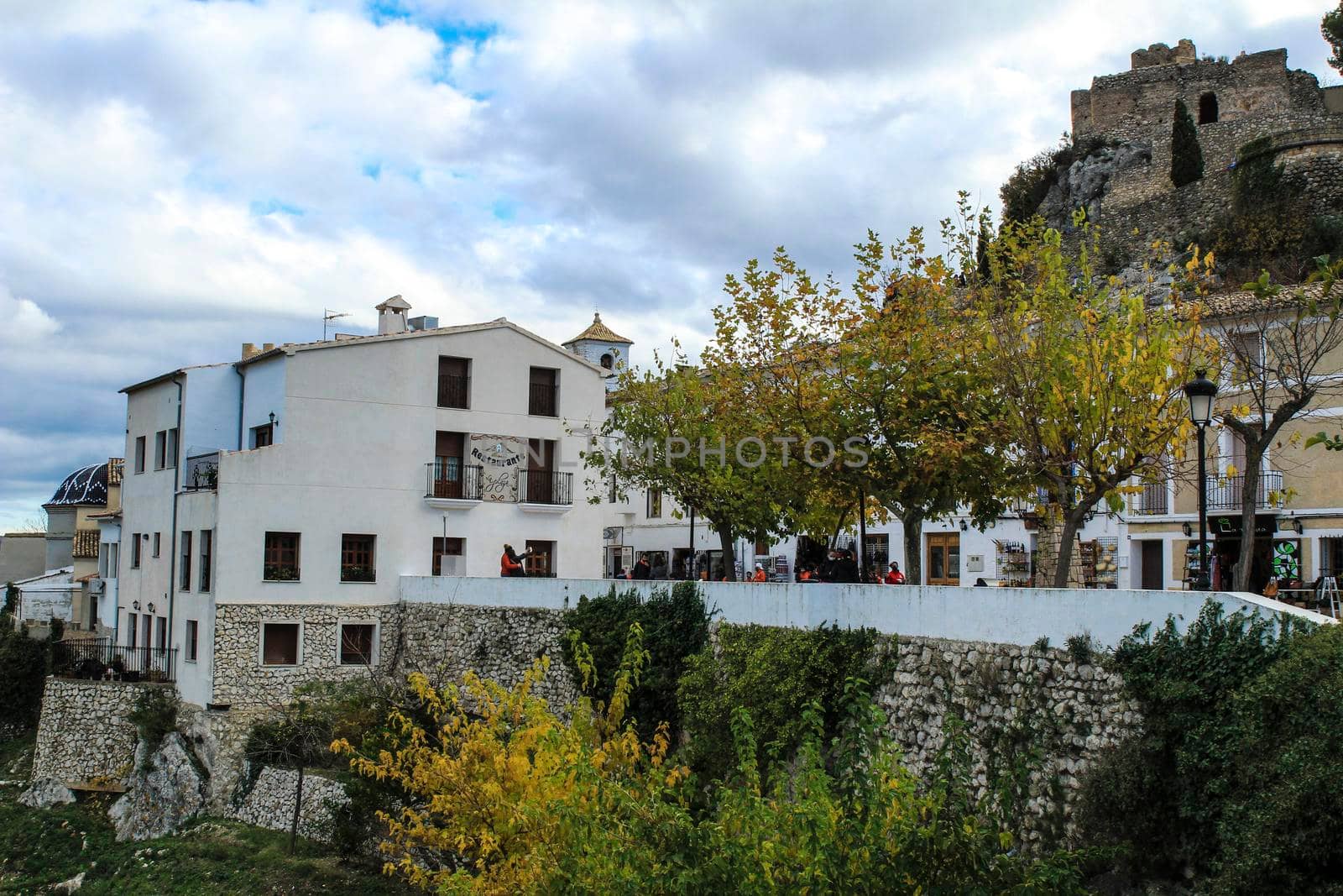 Beautiful view of Guadalest village surrounded by vegetation, mountains and the walls of the Castle