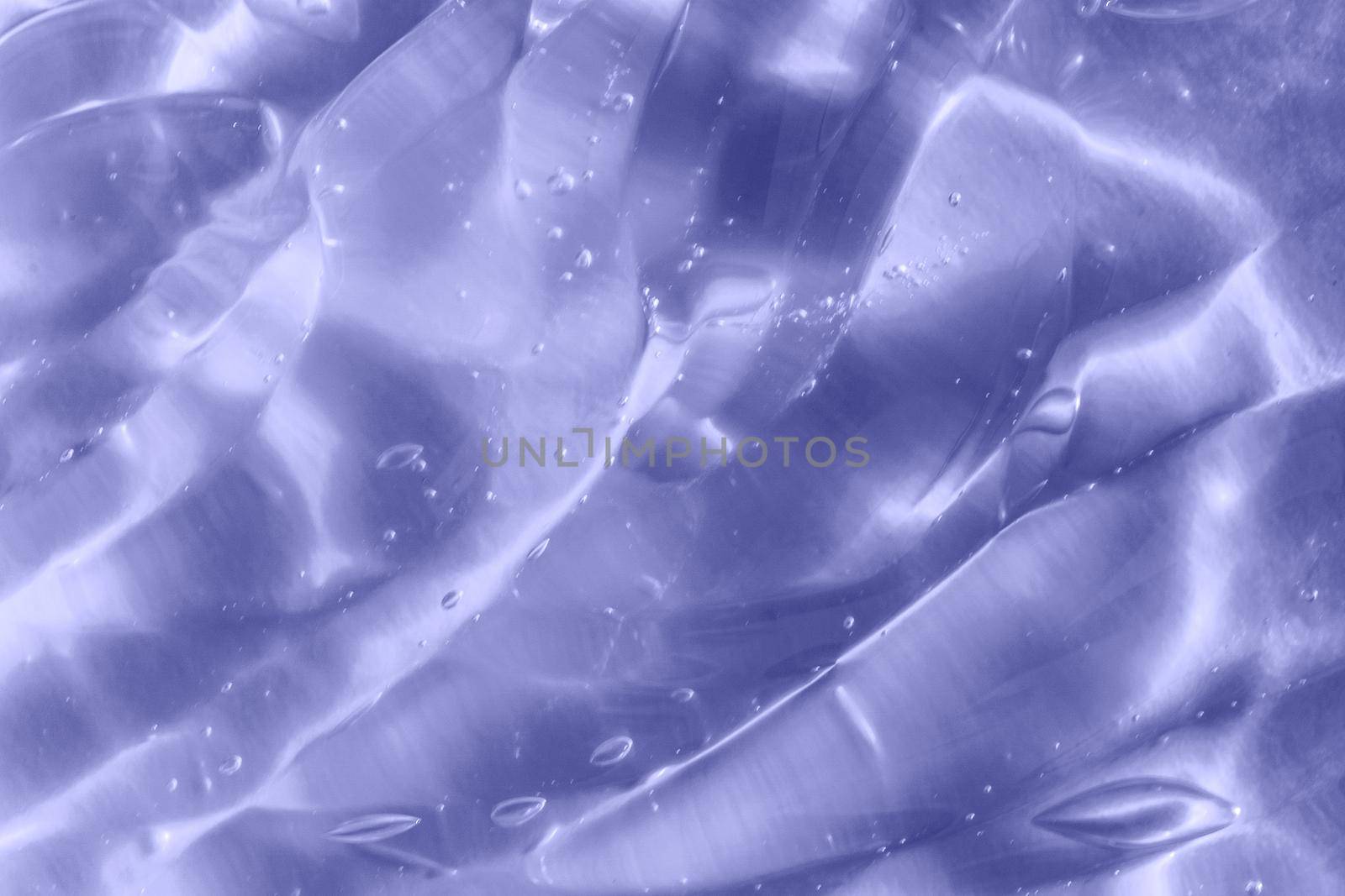 Color of the year 2022. Texture of transparent light violet blue gel with air bubbles and waves on soft background by lavsketch