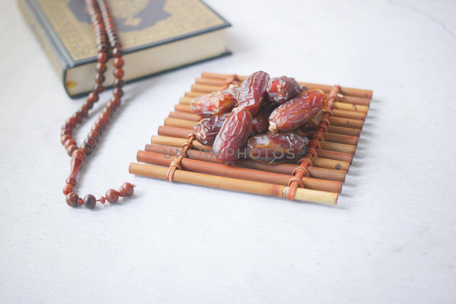 Holy book Quran and rosary on table, close up
