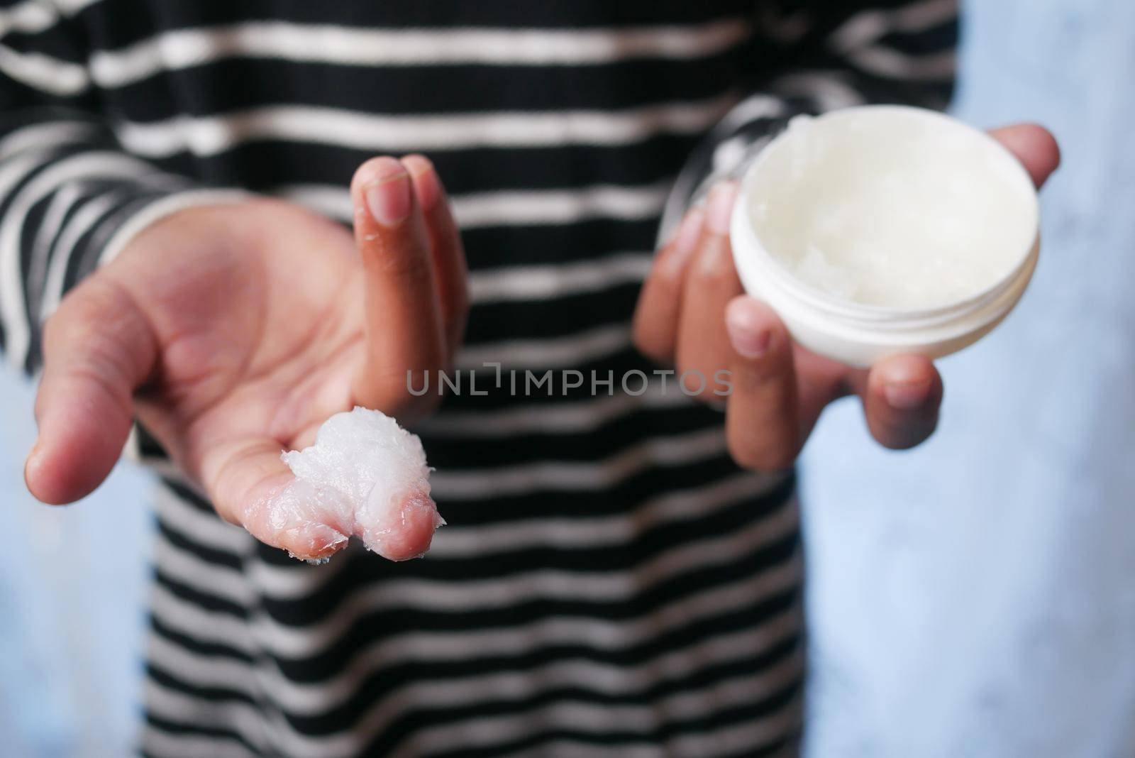 Close up of man hand using petroleum jelly .