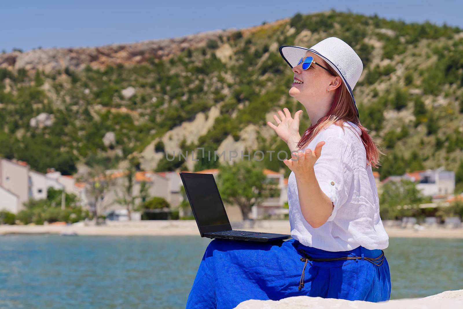 Lifestyle freelance woman using laptop working and relax on the beach. Business and Summer Concept. remote office concept.