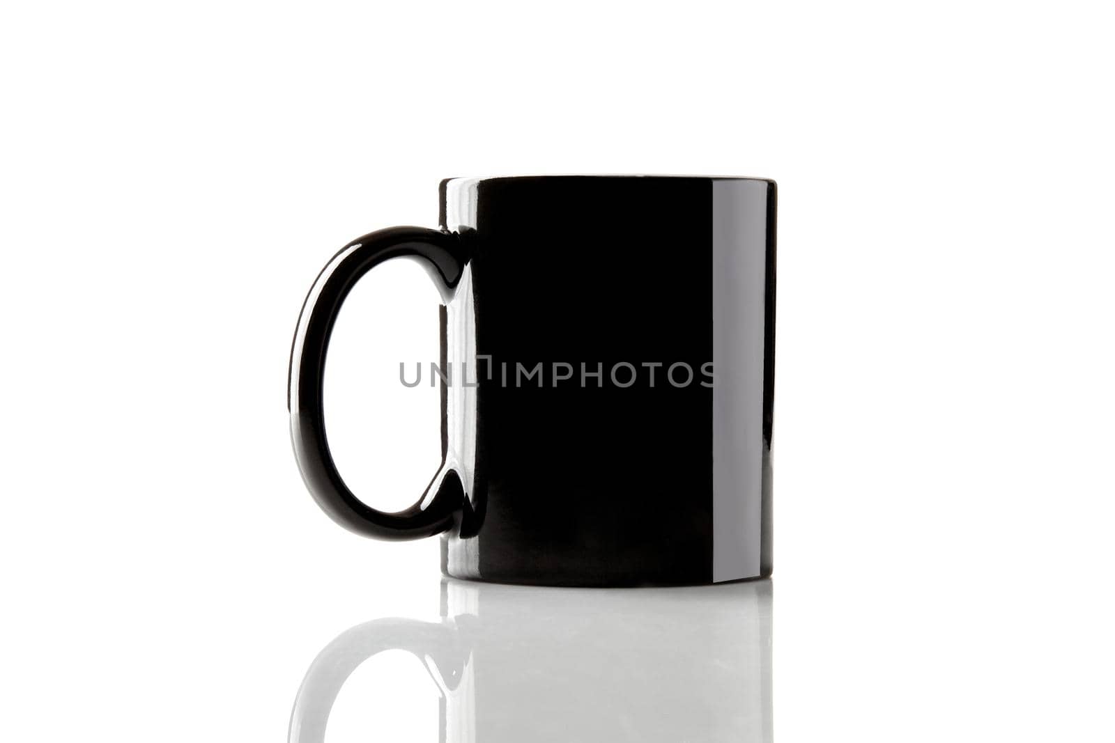 Black ceramic cup for coffee or tea on glossy surface isolated on white studio background. Mock up, template for ads. Branding area. Close up, copy space for your text or images