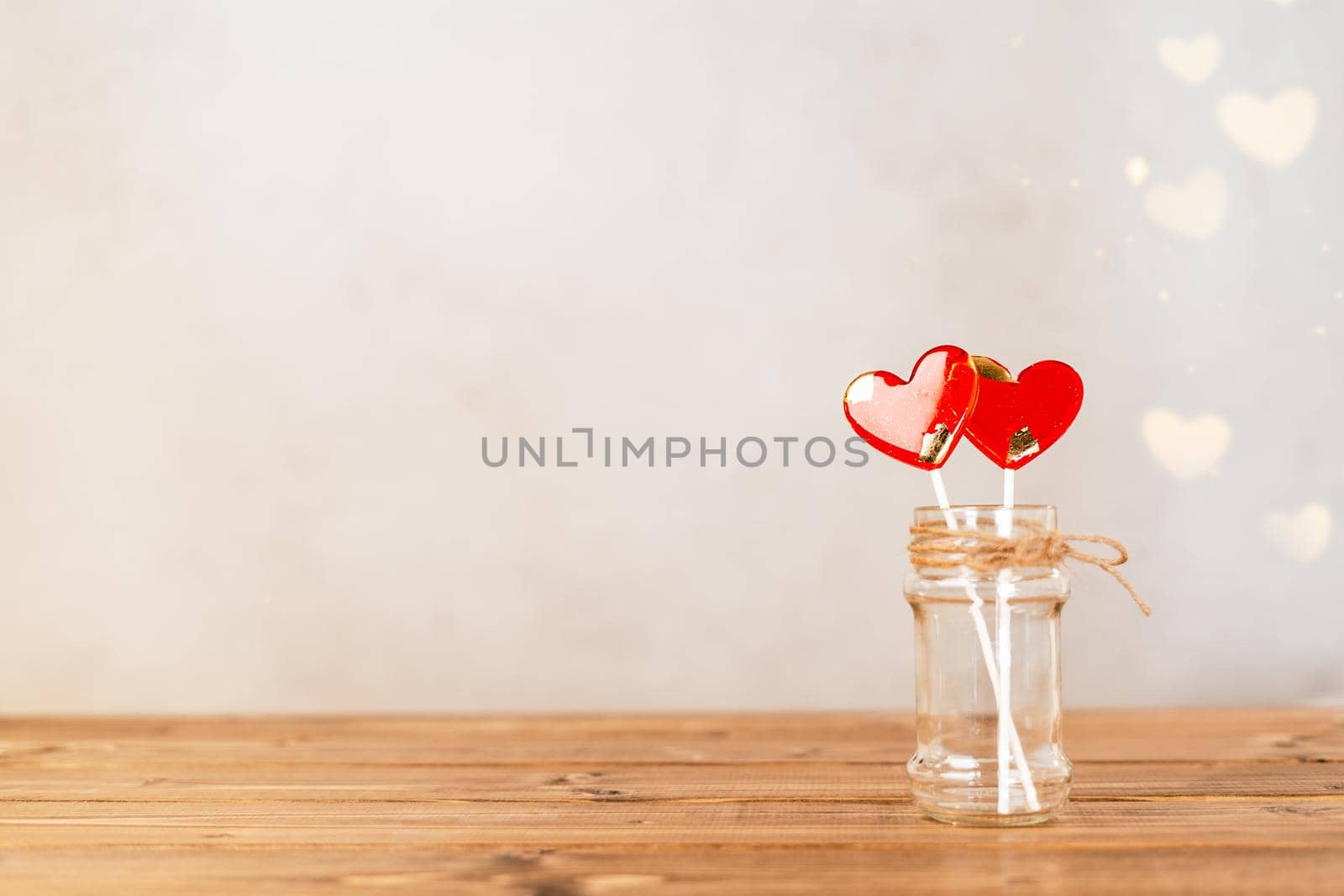 Still life Valentines day festive empty background with 2 red lollipop on wooden table background. Mockup with copy space for design banner.