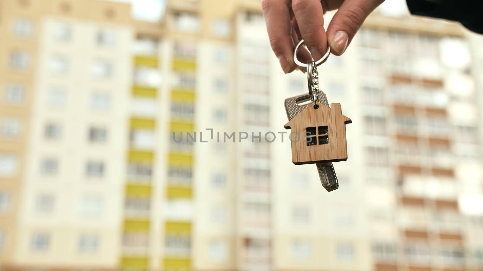 The concept of buying a new apartment. The girl holds the keys to a new apartment