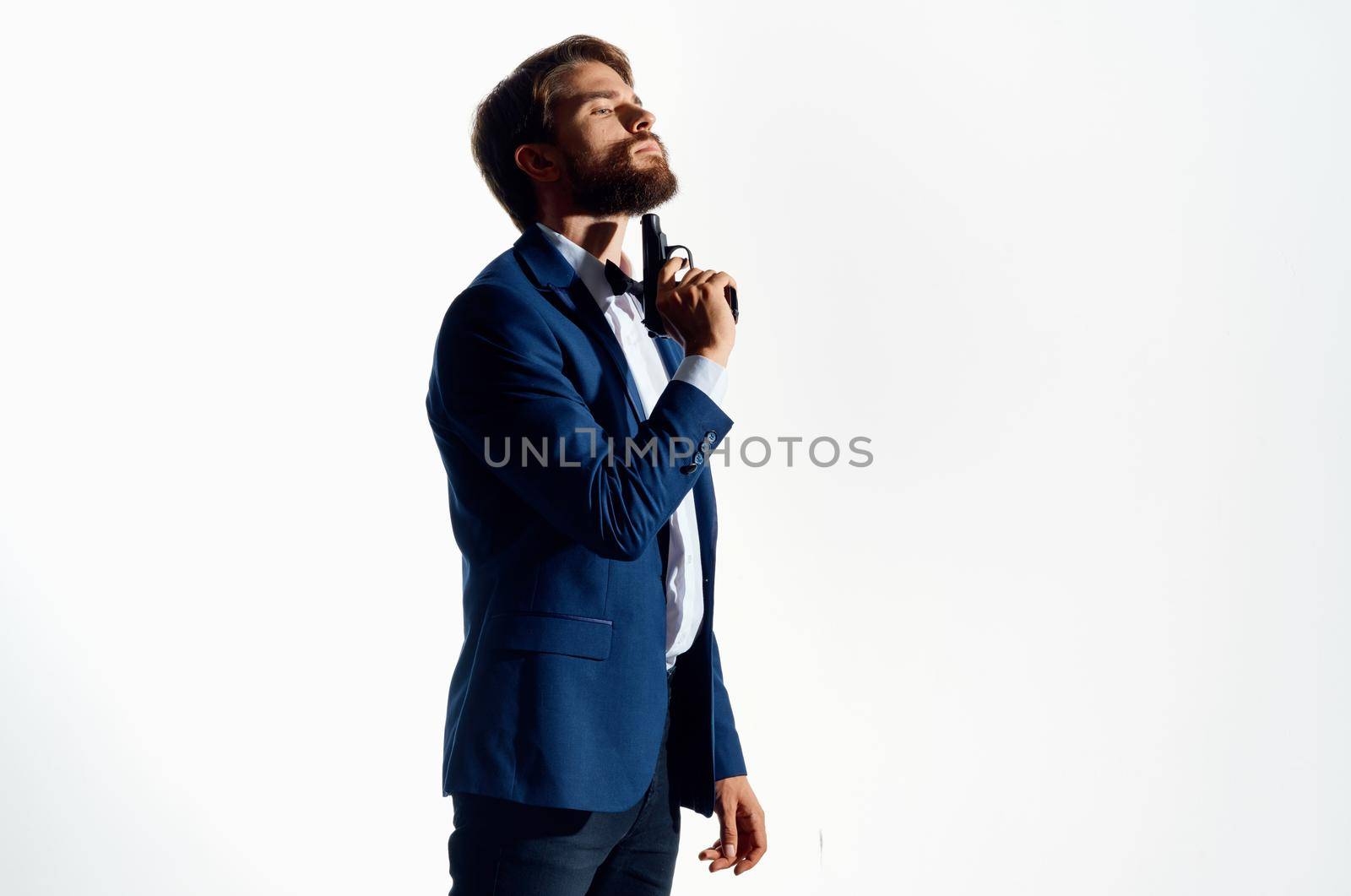businessmen gun in the hands of the mafia emotions Agent posing studio. High quality photo