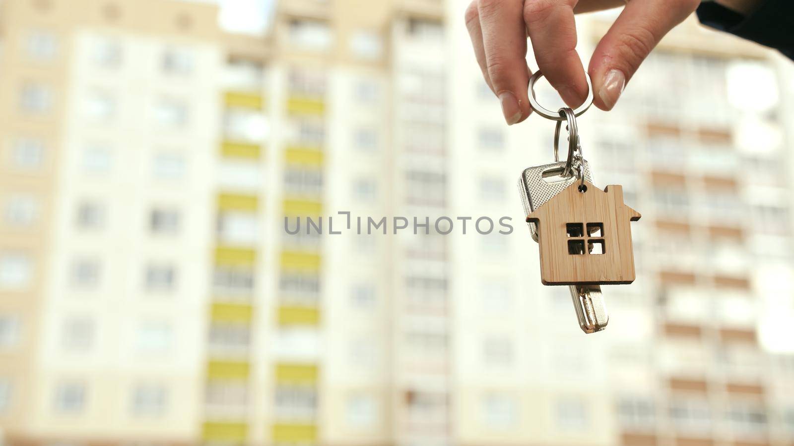 The concept of buying a new apartment. The girl holds the keys to a new apartment.