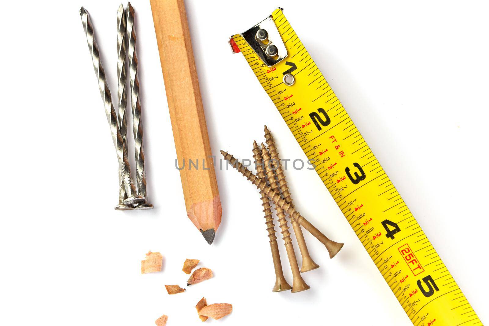 Directly Above Close up of a Carpenter's Pencil with Sharpening Shavings, Tape Measure, Framing Nails and Deck Screws on a white background. High quality photo