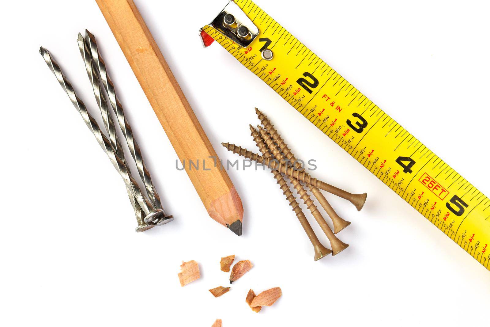 Directly Above Close up of a Carpenter's Pencil with Sharpening Shavings, Tape Measure, Framing Nails and Deck Screws on a white background. High quality photo