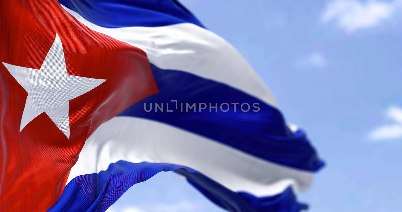 Detailed close up of the national flag of Cuba waving in the wind on a clear day by rarrarorro