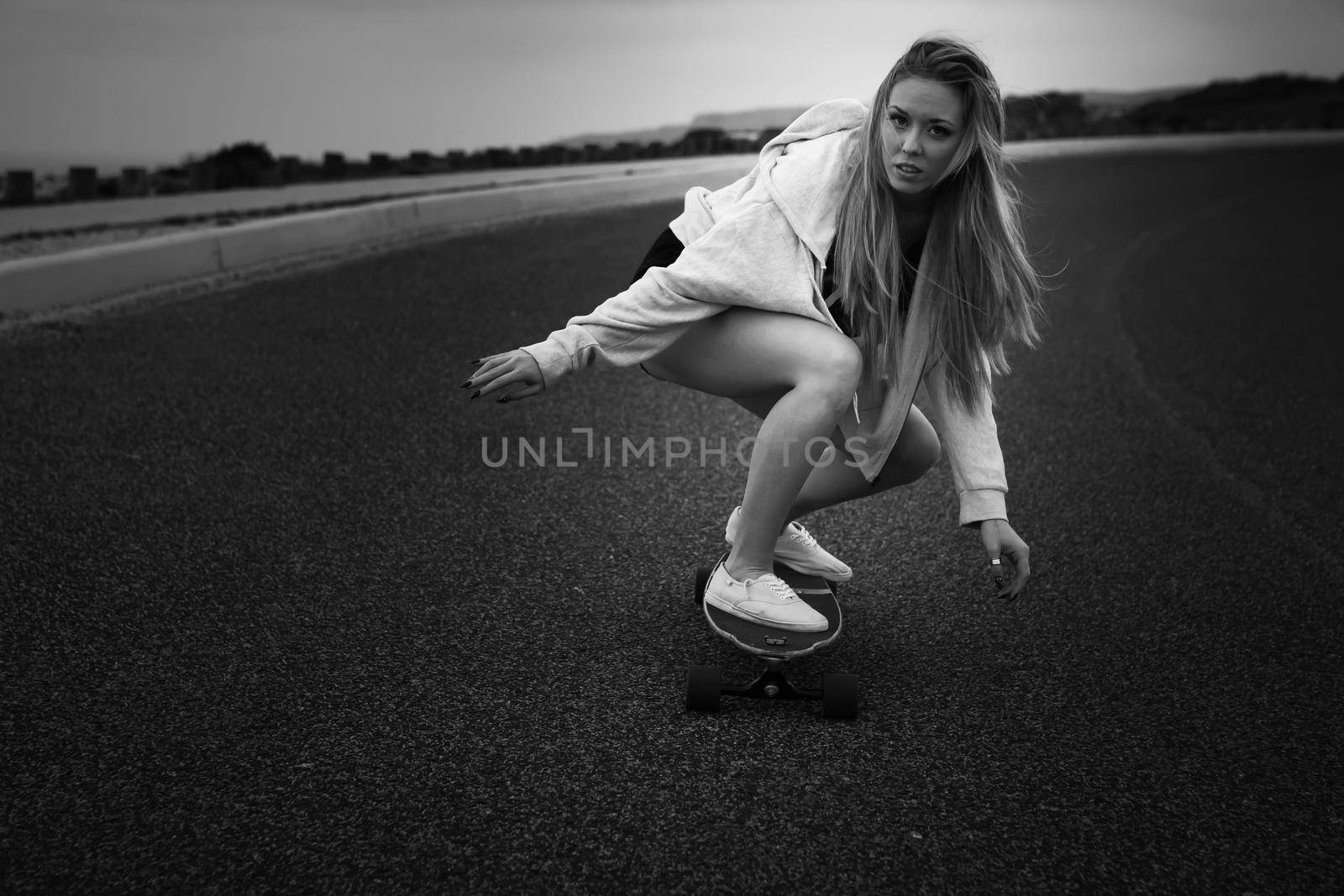 Girl making a downhill with her Skate