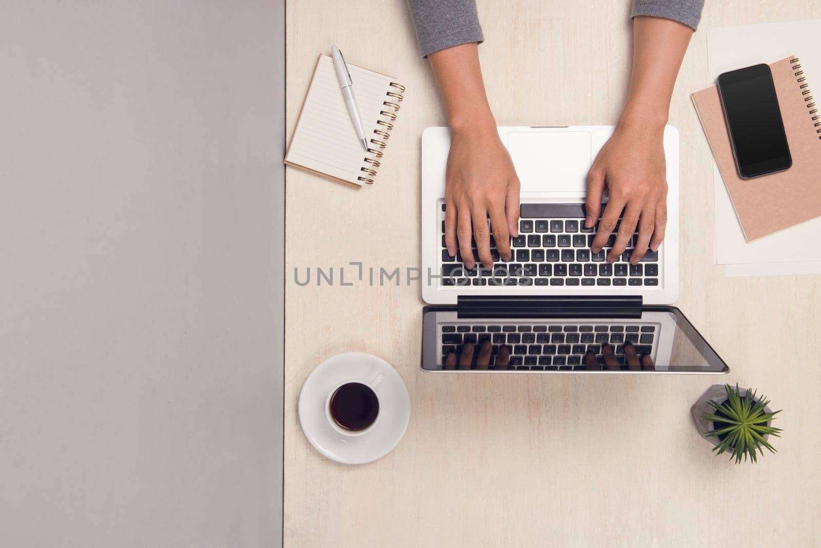 Businessman working at office desk and using laptop, top view. by makidotvn