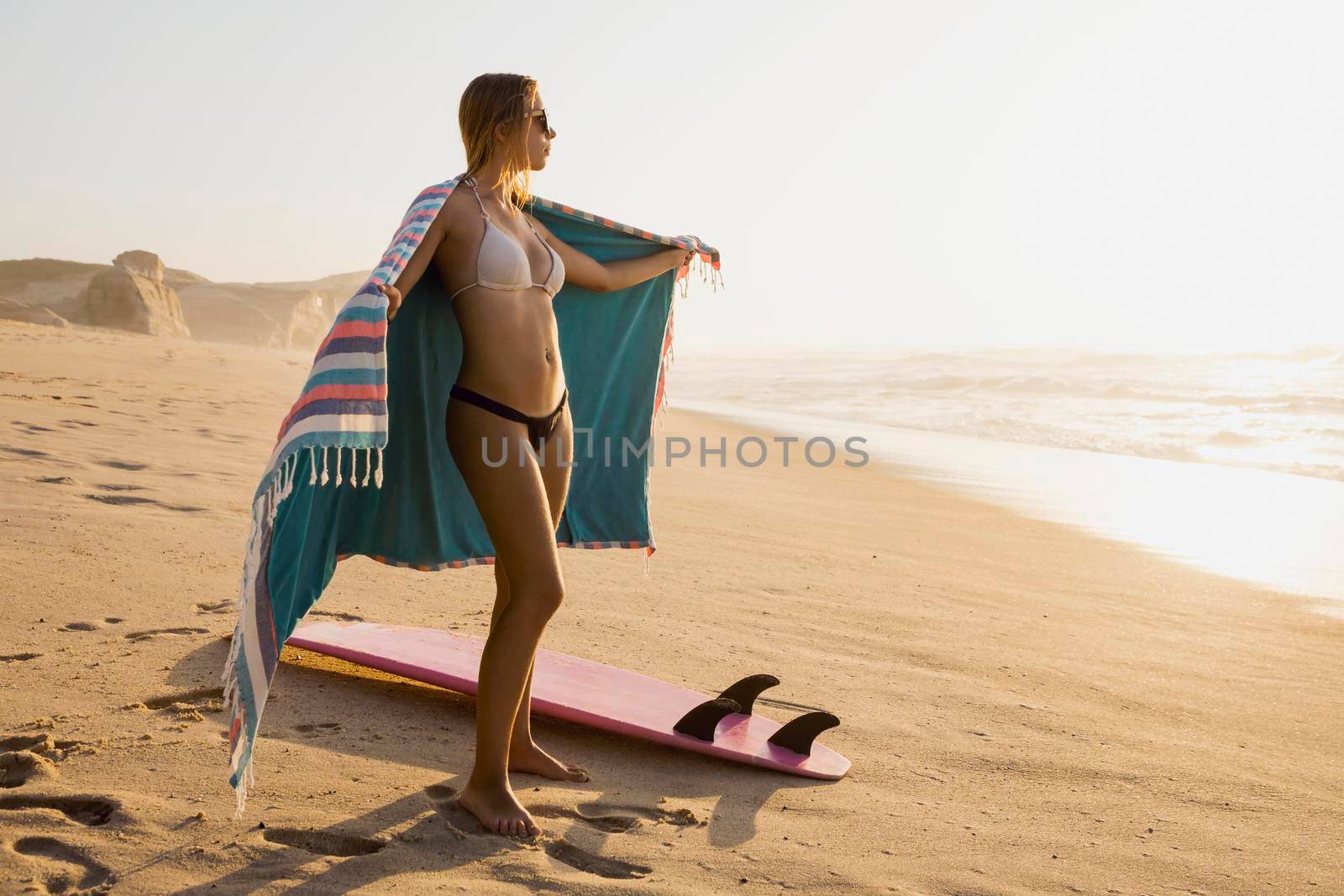 A beautiful girl at the beach with her bodyboard