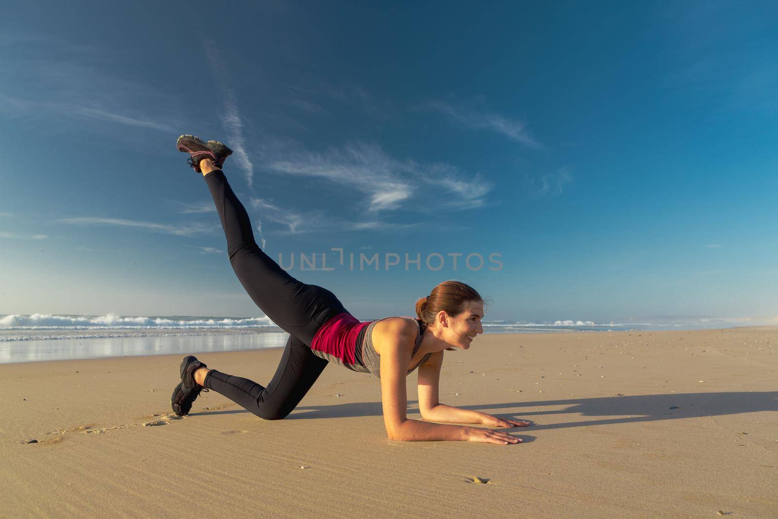 Shoot of a beautiful woman exercising herself in the beach