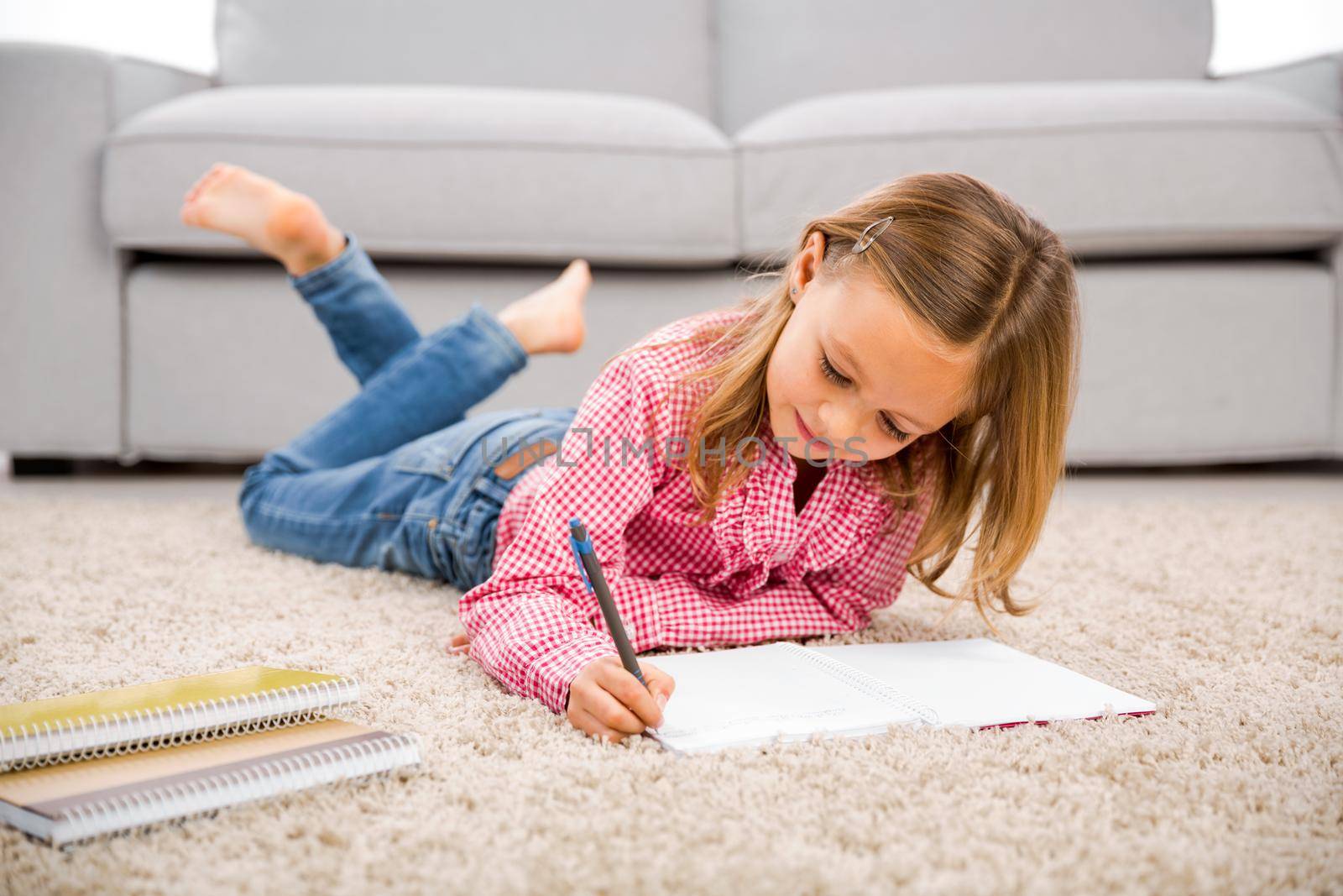 Cute little girl at home studying