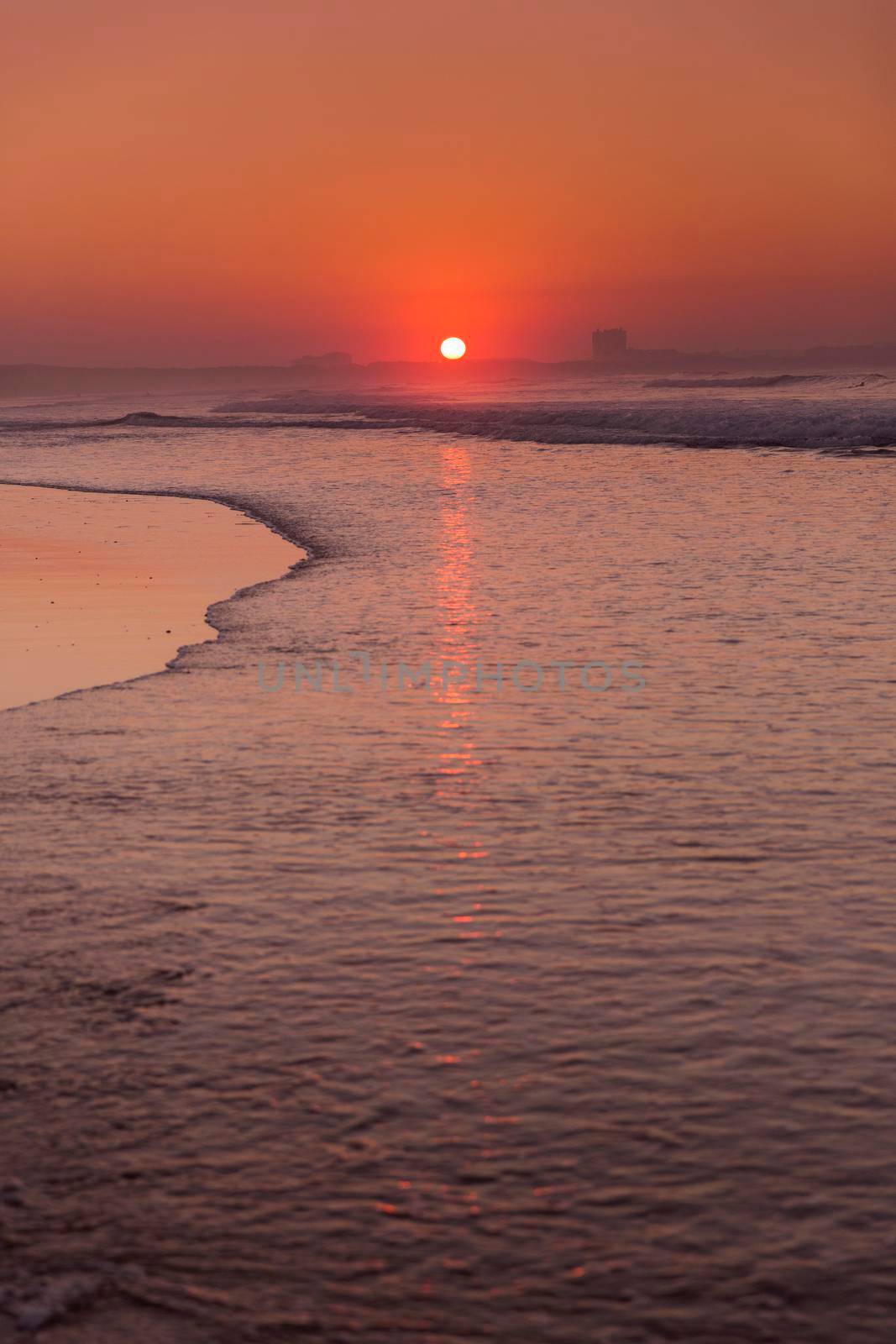 Beautiful orange sunset at the beach of Baleal in Peniche, Portugal