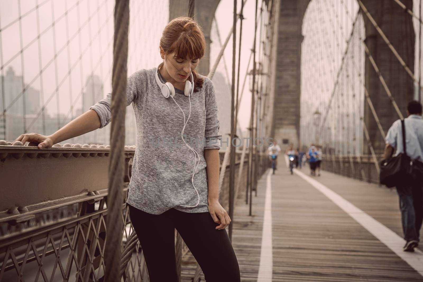Woman on the Brooklyn bridge making a pause after the exercise