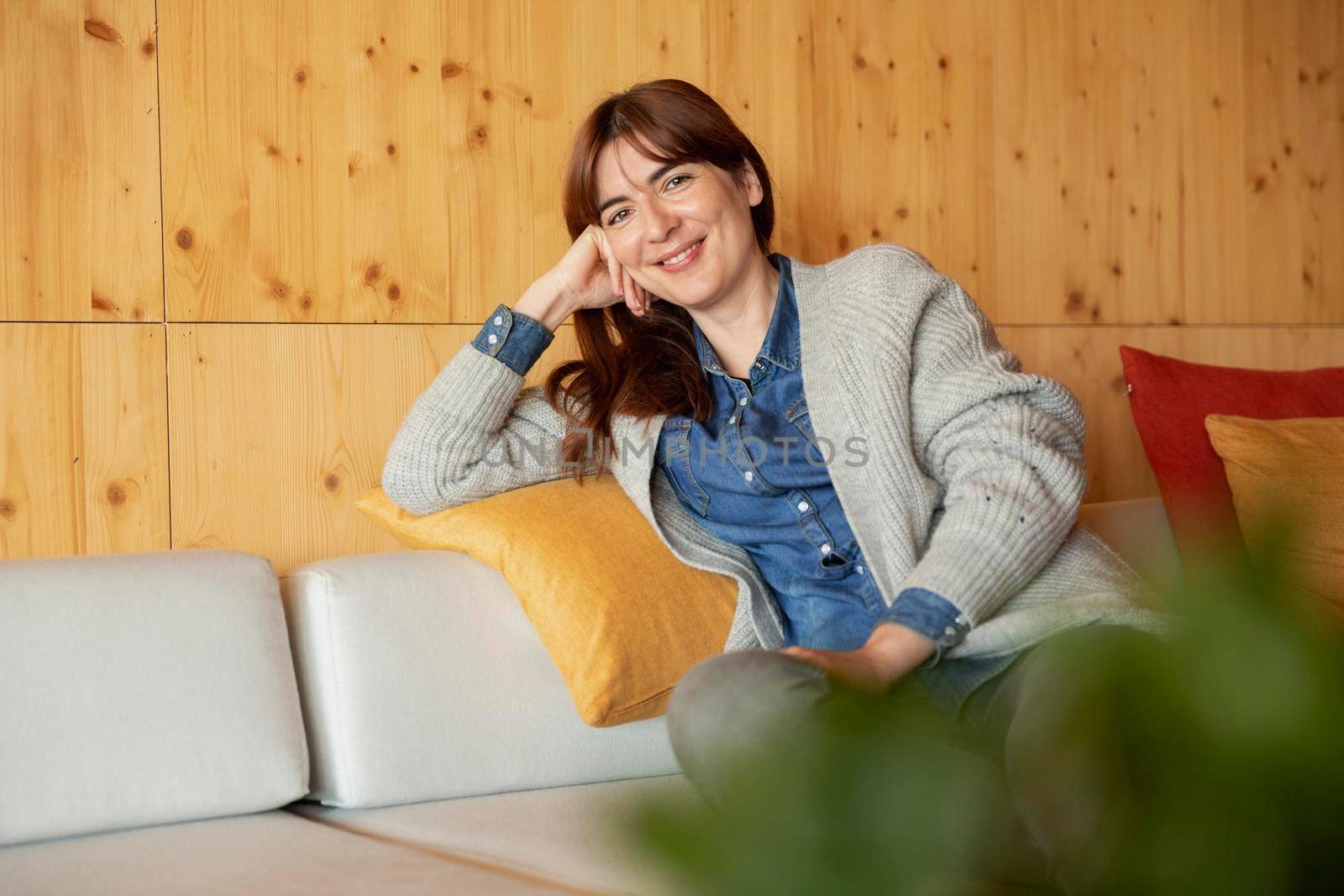 Beautiful woman sitting and relaxing on a cozy place