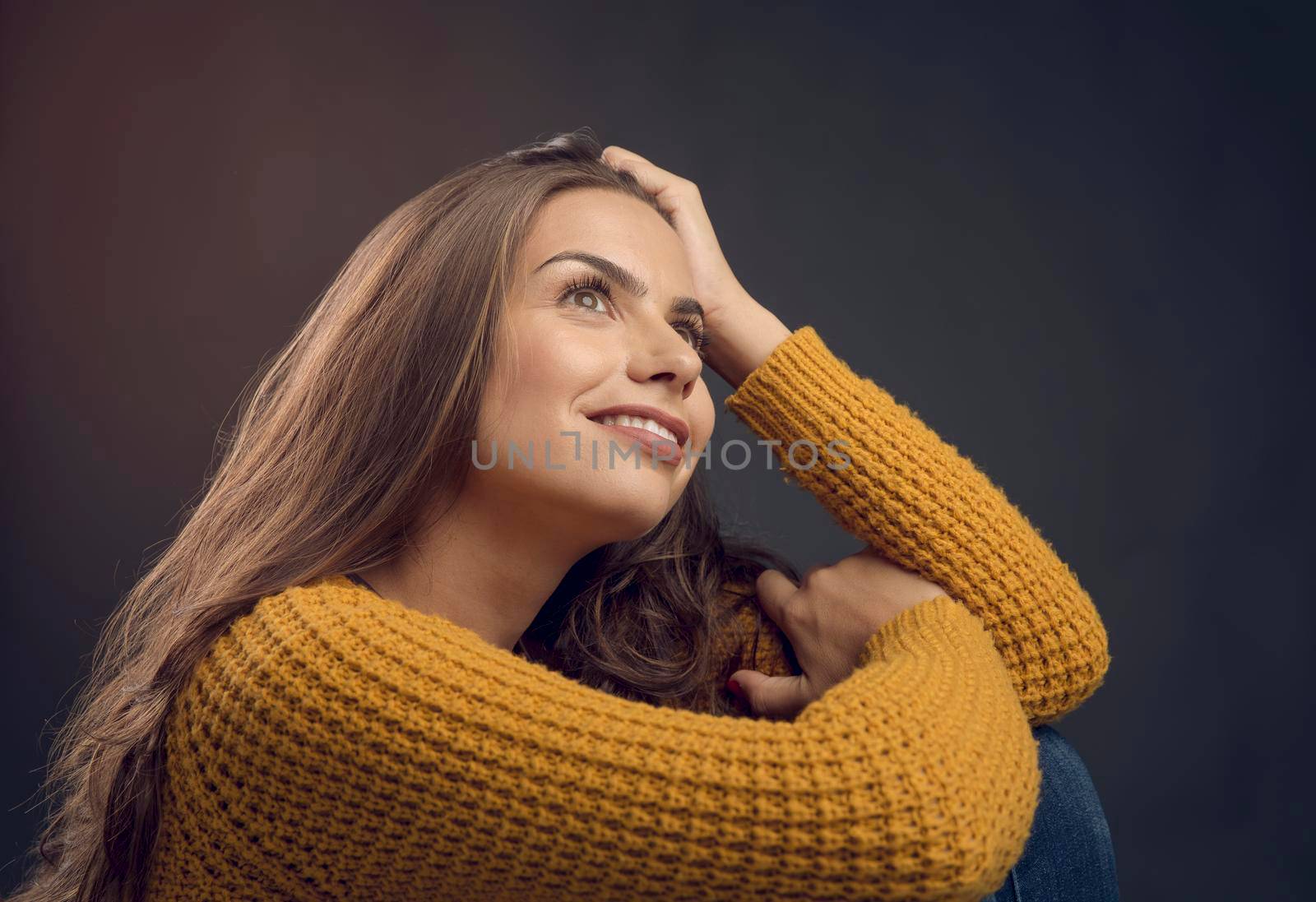Shot of a beautiful young woman smiling and thinking