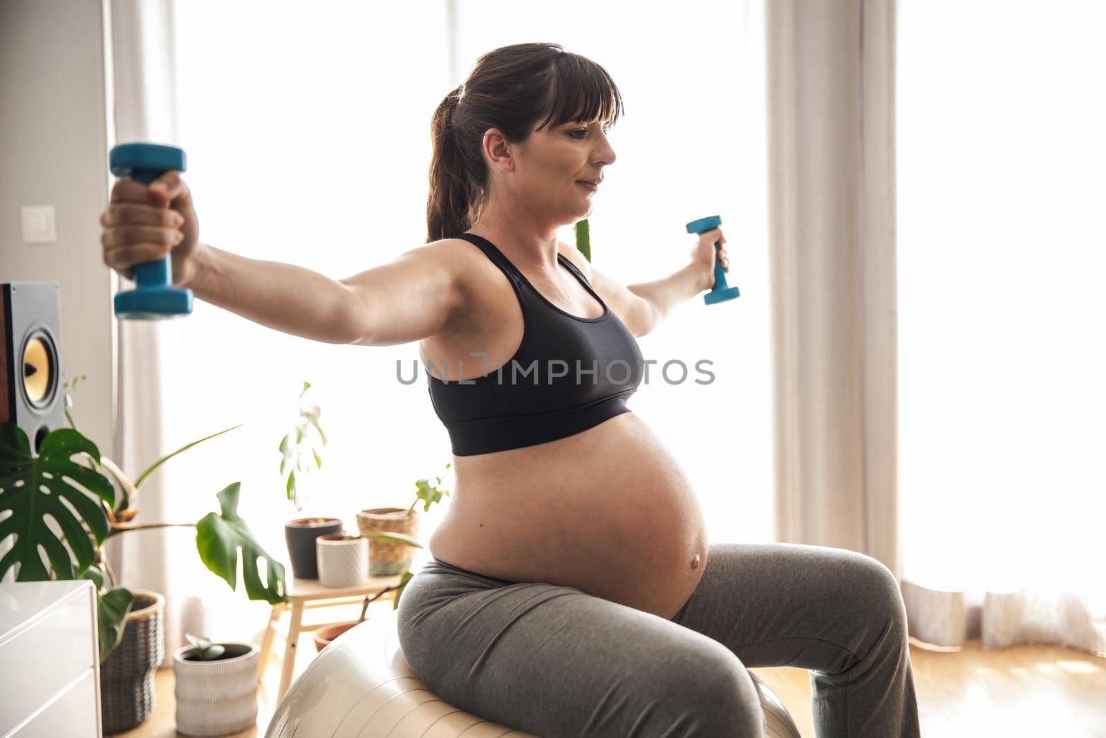 Pegnant woman doing exercise by Iko