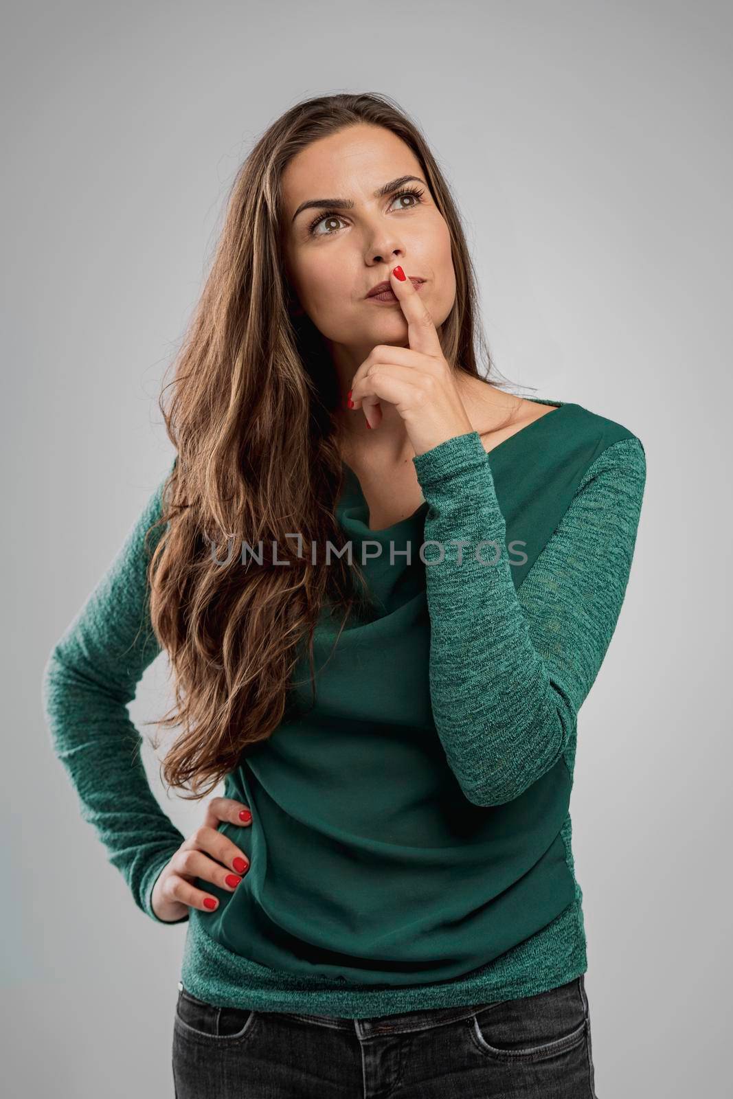 Beautiful woman thinking on something with hand on the chin