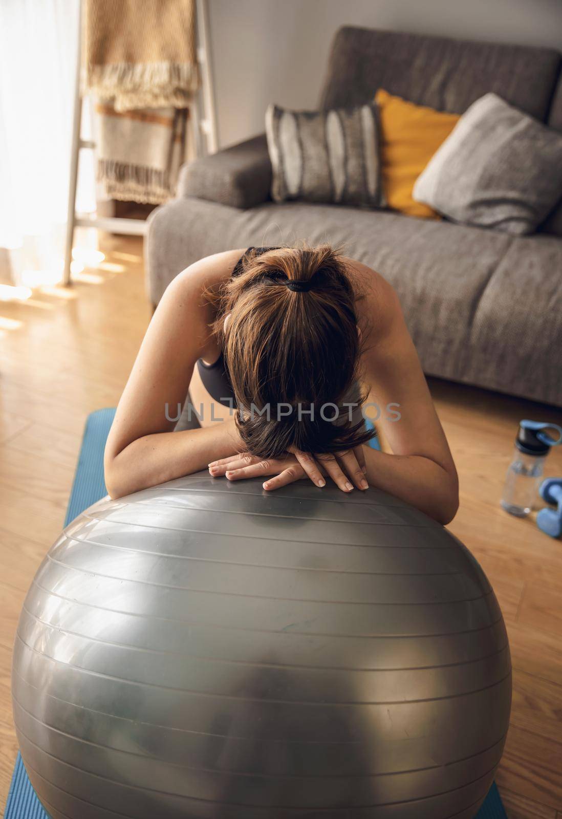 Pegnant woman doing exercise at home by Iko