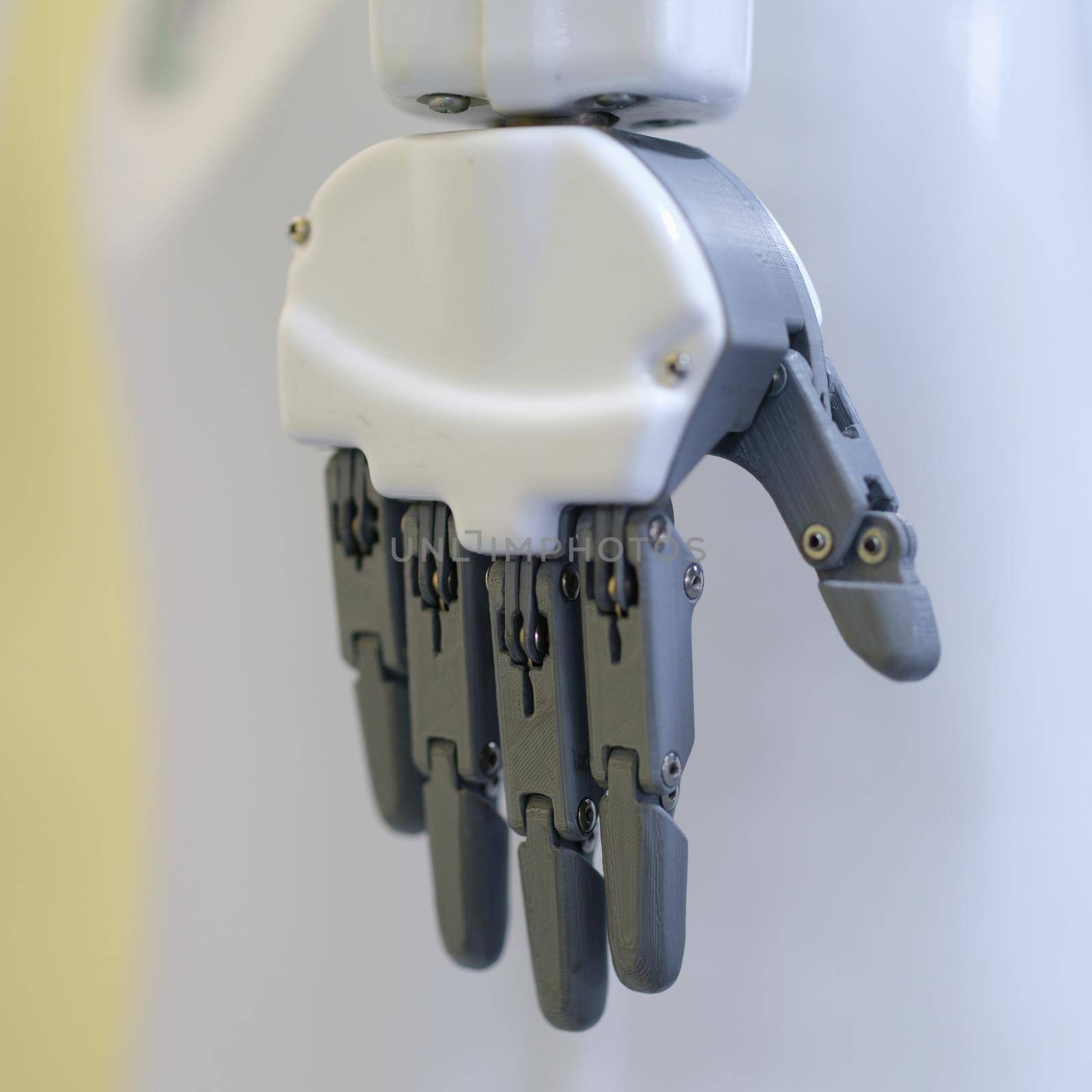 Metal robot hand on a gray background, close-up by kuprevich