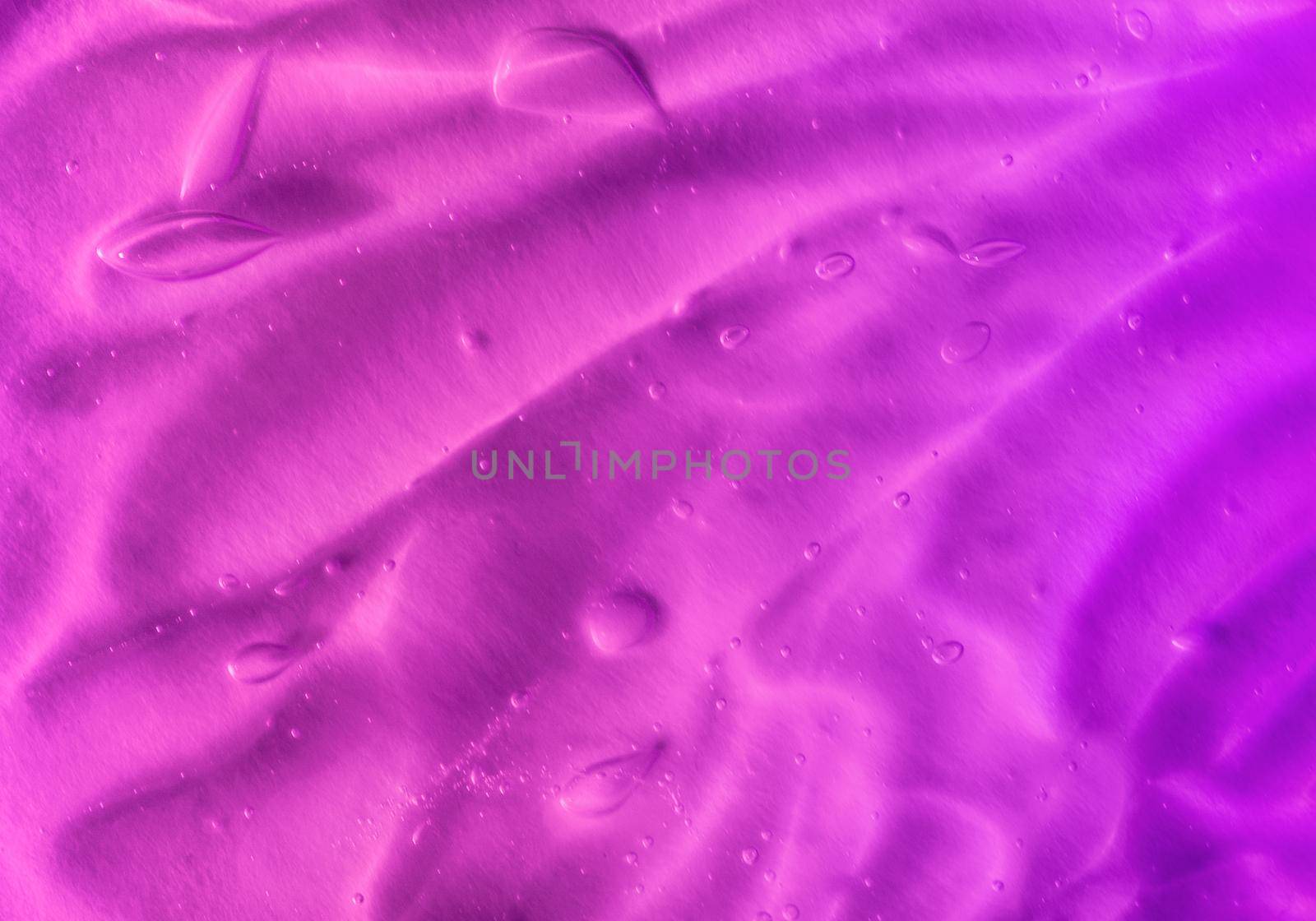 Texture of transparent violet gel with air bubbles and waves on orange background by lavsketch