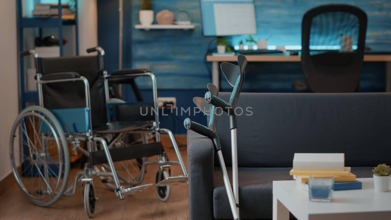 Nobody in living room with wheelchair and crutches to help with transportation by DCStudio
