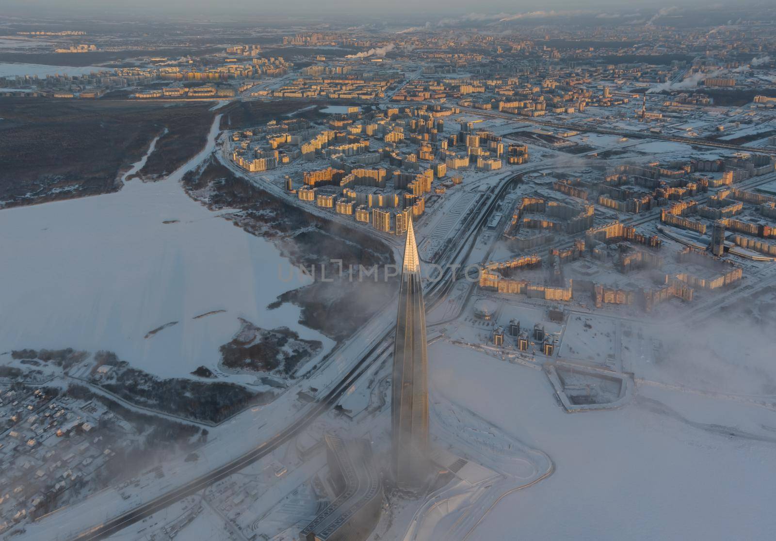 Russia, St. Petersburg, 08 January 2022: Lakhta center skyscraper in a winter frosty evening at sunset, the future main building of the office of the oil company Gazprom, buildings of pink color. High quality photo