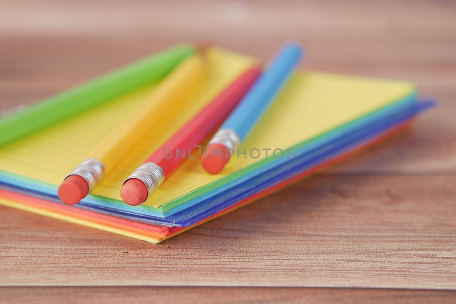 Close up of colorful pencils on notepad .