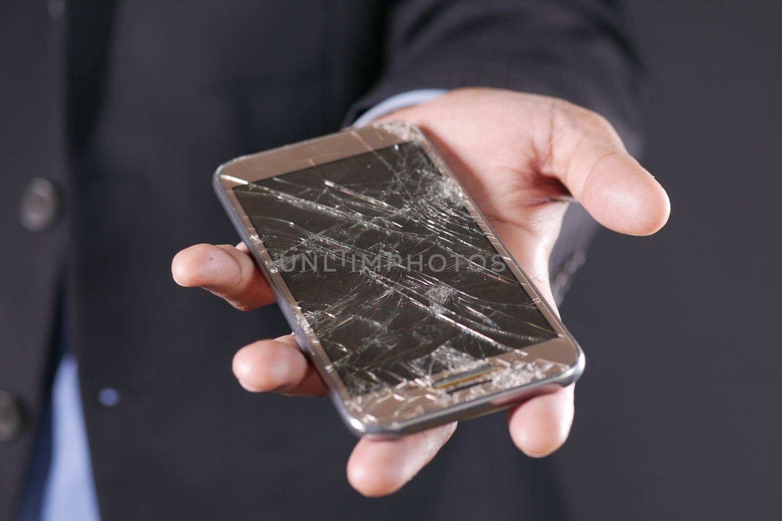 Close up of man hand holding broken smart phone