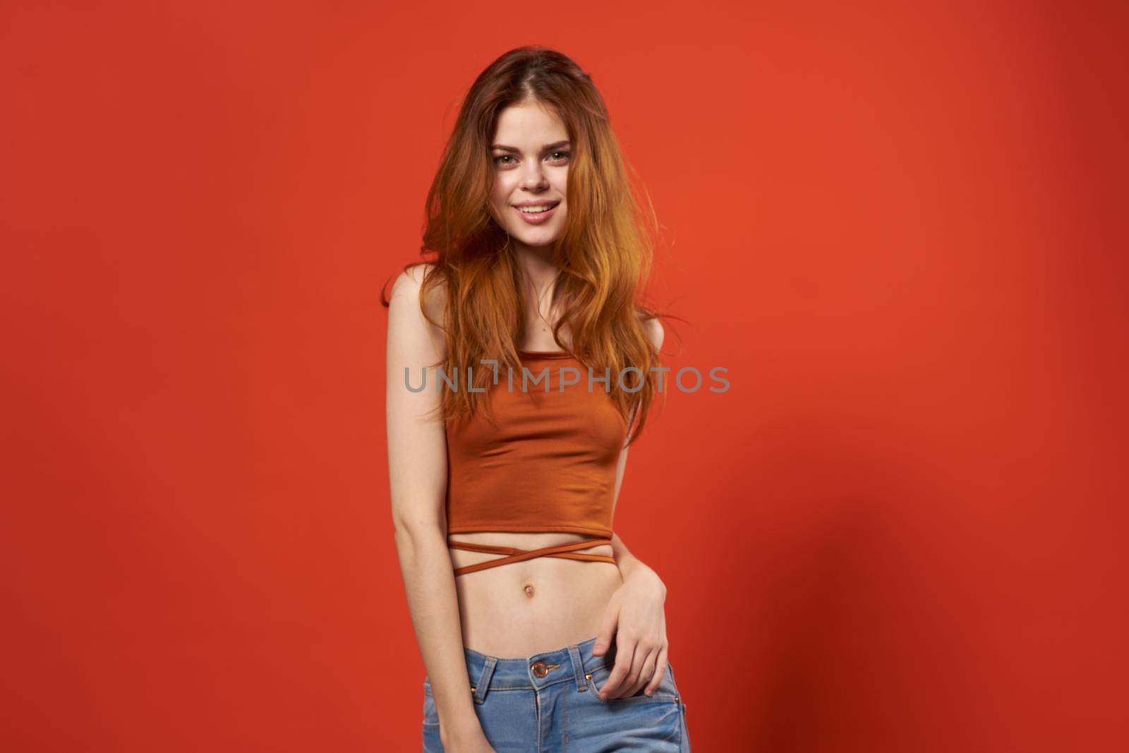 cheerful woman in a red t-shirt fashion hairstyle Glamor red background by SHOTPRIME
