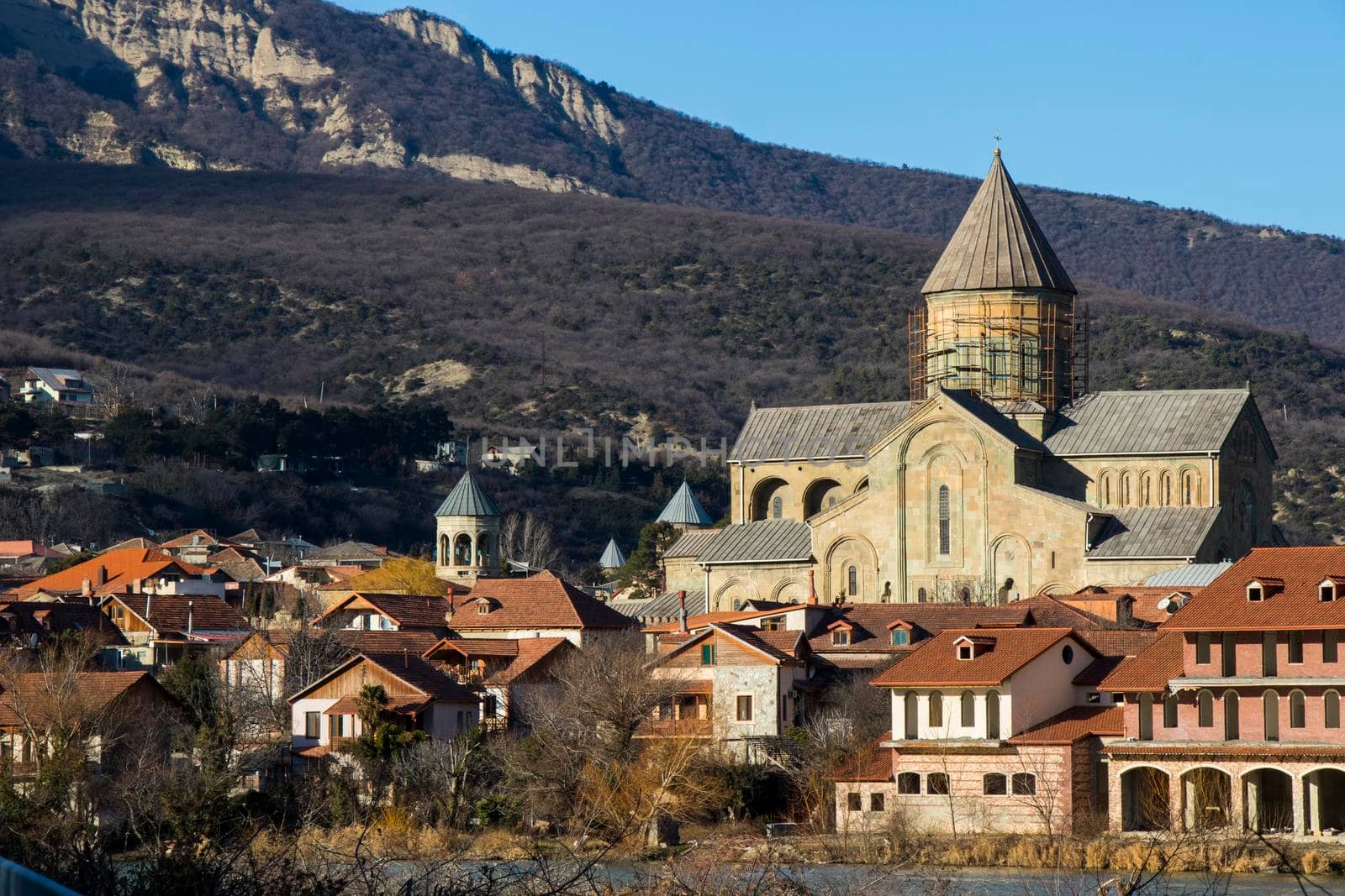 Mtskheta, Georgia - January 14, 2022: Old famous town in Georgia, Mtskheta. Old houses travel destination. Svetitshkoveli cathedral and church view.