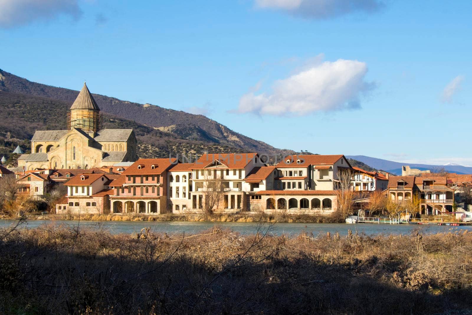 Mtskheta, Georgia - January 14, 2022: Old famous town in Georgia, Mtskheta. Old houses travel destination. Svetitshkoveli cathedral and church view.