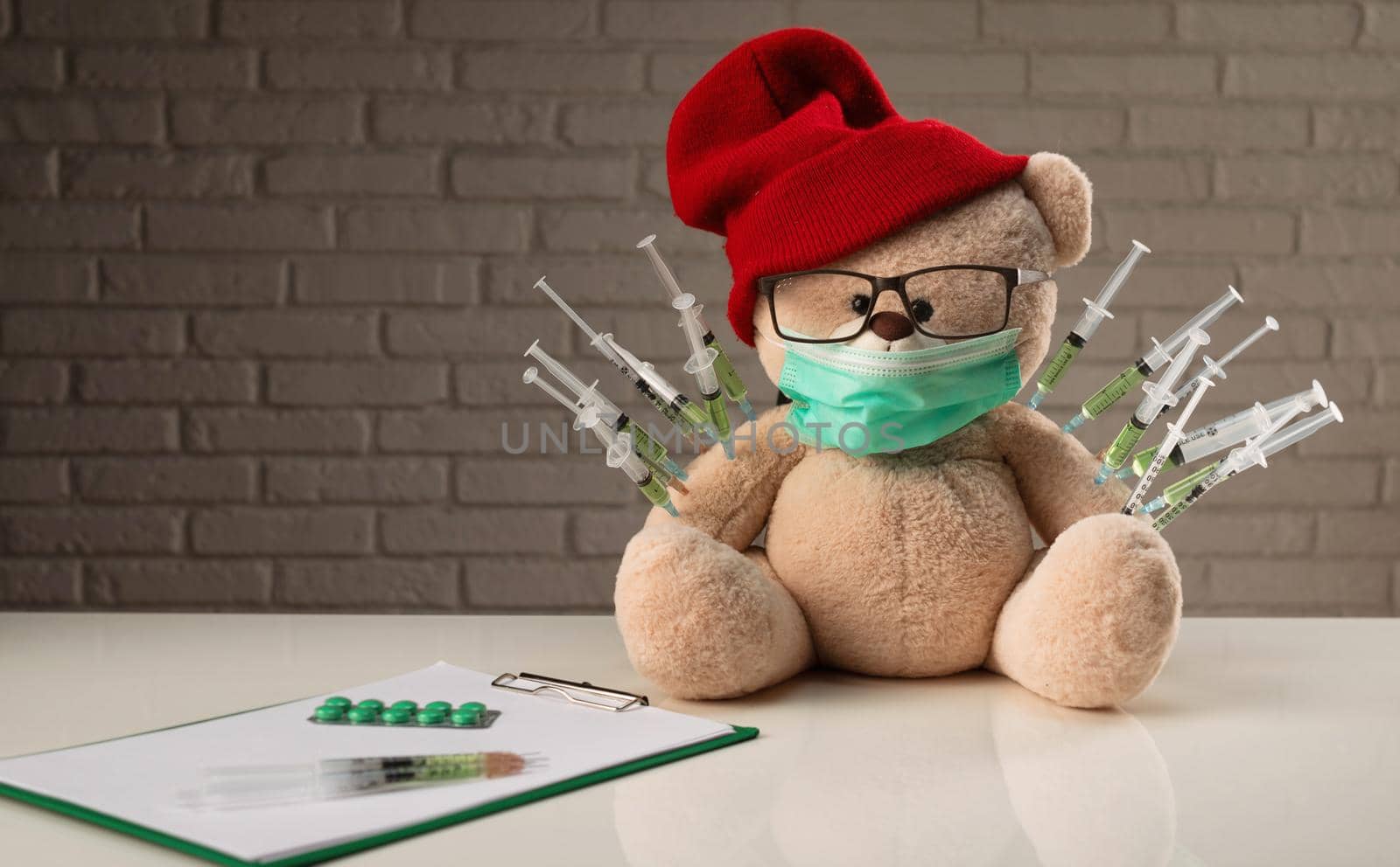 the children's vaccination against the covid19 virus and vaccinations on the example of a teddy bear