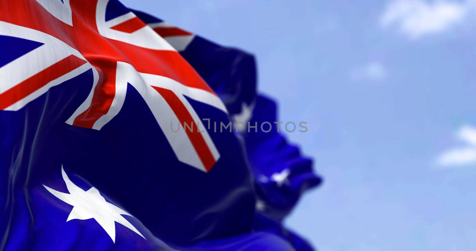 Detailed close up of the national flag of Australia waving in the wind on a clear day. Democracy and politics. Australian continent. Selective focus.